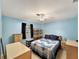 Bedroom featuring a bed, dresser, ceiling fan, and a window with natural light at 2340 Ne 44Th St, Ocala, FL 34479