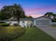 Charming single-story home featuring well-maintained landscaping, a palm tree, and an attached garage, perfect for suburban living at 2340 Ne 44Th St, Ocala, FL 34479