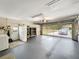 Bright garage featuring gray epoxy floors, storage, washer, dryer, and large glass door bringing in natural light at 2340 Ne 44Th St, Ocala, FL 34479