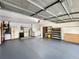 Spacious garage featuring a modern gray epoxy floor, storage shelves, and essential utility appliances for added convenience at 2340 Ne 44Th St, Ocala, FL 34479
