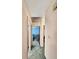 Hallway view leading to a bedroom with blue walls and neutral decor at 2340 Ne 44Th St, Ocala, FL 34479