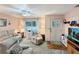 Inviting living room featuring cozy seating, ceiling fan, and lots of natural light at 2340 Ne 44Th St, Ocala, FL 34479