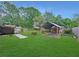 Backyard shed under a metal roof, offering ample storage space and blending seamlessly with the lush green surroundings at 2340 Ne 44Th St, Ocala, FL 34479