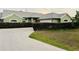 Charming single-story home with a well-manicured lawn, concrete driveway, and lush green landscaping at 2910 Ne 24Th Pl, Ocala, FL 34470