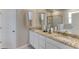 Bathroom featuring double sinks with granite countertops and a glass-enclosed shower at 3076 Canopy Oak Blvd, Wildwood, FL 34785