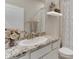 Bathroom featuring granite countertops, white cabinets, and a stylish vanity at 3076 Canopy Oak Blvd, Wildwood, FL 34785
