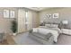 Serene bedroom with large windows and seating area at 3076 Canopy Oak Blvd, Wildwood, FL 34785