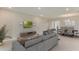 Open concept living room leading into a dining area with modern decor and ample space at 3076 Canopy Oak Blvd, Wildwood, FL 34785