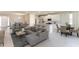 Open-concept living space with kitchen, living room, and dining area with lots of natural light at 3076 Canopy Oak Blvd, Wildwood, FL 34785