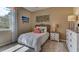This is a well-lit bedroom with neutral decor, a full size bed and carpeted floors at 3080 Canopy Oak Blvd, Wildwood, FL 34785