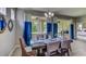 Bright dining area with stylish furnishings, a dining table set for six, and lots of light at 3080 Canopy Oak Blvd, Wildwood, FL 34785
