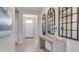 Inviting entryway featuring decorative mirrors, a console table, and neutral décor at 3080 Canopy Oak Blvd, Wildwood, FL 34785