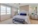 Serene bedroom with a neutral color palette, large windows and mirrored closet doors at 3080 Canopy Oak Blvd, Wildwood, FL 34785