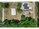 Aerial view of the property showcases the home, adjacent shop, and surrounding lot at 3112 Se 140Th Ln, Summerfield, FL 34491