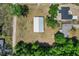 Bird's eye view of a home and a large shop on a sprawling lot surrounded by trees at 3112 Se 140Th Ln, Summerfield, FL 34491