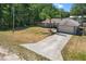 Aerial view of a home with a long driveway leading to a two-car garage and well-manicured front yard at 3112 Se 140Th Ln, Summerfield, FL 34491