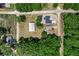 Aerial view of property showcasing the homes, storage building, and surrounding tree coverage at 3112 Se 140Th Ln, Summerfield, FL 34491