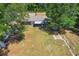 Aerial view of the backyard highlighting the open space and the back of the single-story home at 3112 Se 140Th Ln, Summerfield, FL 34491