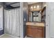 A functional bathroom with a shower, single sink vanity, and ample lighting at 3112 Se 140Th Ln, Summerfield, FL 34491