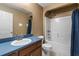 Bathroom featuring a blue countertop, a shower-tub combo and neutral beige walls at 3112 Se 140Th Ln, Summerfield, FL 34491