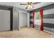 Bedroom featuring a closet and unique blue-gray striped walls, ceiling fan at 3112 Se 140Th Ln, Summerfield, FL 34491