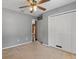 Bedroom featuring a closet and a ceiling fan with neutral colored carpet at 3112 Se 140Th Ln, Summerfield, FL 34491