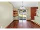 Bright dining area featuring hardwood floors and sliding glass doors at 3112 Se 140Th Ln, Summerfield, FL 34491