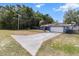 Long driveway leading to a well-kept single-story home with mature trees at 3112 Se 140Th Ln, Summerfield, FL 34491