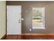 Entryway showcasing the front door and a bright window with natural light at 3112 Se 140Th Ln, Summerfield, FL 34491