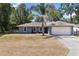 Charming single-story home with a spacious lawn and a two-car garage at 3112 Se 140Th Ln, Summerfield, FL 34491