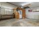 A spacious garage featuring a workbench, shelving, and ample room for projects and storage at 3112 Se 140Th Ln, Summerfield, FL 34491