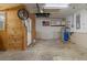 Inside a functional garage with water heater, fan, utility sink and shelving at 3112 Se 140Th Ln, Summerfield, FL 34491