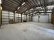 Spacious workshop area with metal walls, storage racks and two large garage doors at 3112 Se 140Th Ln, Summerfield, FL 34491