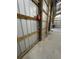 Close up of workshop wall showcasing the metal corrugated wall, wooden supports and outlets at 3112 Se 140Th Ln, Summerfield, FL 34491