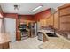 Functional kitchen with stainless steel appliances, tile countertops, and wooden cabinets at 3112 Se 140Th Ln, Summerfield, FL 34491