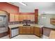 Well-lit kitchen featuring ample counter space and stylish tile backsplash with adjacent living area at 3112 Se 140Th Ln, Summerfield, FL 34491