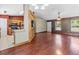 Open-concept layout with hardwood floors connecting the living room and kitchen at 3112 Se 140Th Ln, Summerfield, FL 34491
