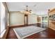 Cozy living room features hardwood floors, ceiling fan, and sliding glass doors at 3112 Se 140Th Ln, Summerfield, FL 34491