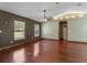 Spacious living room with hardwood floors, ceiling fan, and neutral walls. Natural light pours in at 3112 Se 140Th Ln, Summerfield, FL 34491