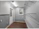 A storage room with shelving, pegboard walls, and a door for organization and easy access at 3112 Se 140Th Ln, Summerfield, FL 34491