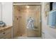 Close-up of bathroom shower stall with glass doors, built-in shelves, and tan tile at 3449 Sw 19Th St, Ocala, FL 34474