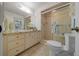 Cozy bathroom featuring a glass shower, tile floors, and neutral-toned cabinets at 3449 Sw 19Th St, Ocala, FL 34474