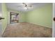 Cozy bedroom with carpet, ceiling fan and access to an enclosed lanai at 3449 Sw 19Th St, Ocala, FL 34474