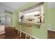 Kitchen breakfast bar with two stools and view into adjacent kitchen at 3449 Sw 19Th St, Ocala, FL 34474