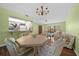 Bright dining area with chandelier, table and seating for six near kitchen at 3449 Sw 19Th St, Ocala, FL 34474