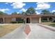 Inviting home with a classic facade, lush landscaping, and an attached garage providing convenient parking at 3449 Sw 19Th St, Ocala, FL 34474