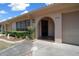 Charming home featuring an arched entryway, well-maintained landscaping, and convenient attached garage at 3449 Sw 19Th St, Ocala, FL 34474