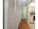 Hallway features hardwood floors and access to kitchen and closets at 3449 Sw 19Th St, Ocala, FL 34474