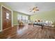 Bright living room features wood floors, ceiling fan, and a large window for plenty of natural light at 3449 Sw 19Th St, Ocala, FL 34474