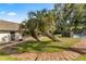 Lush backyard featuring brick patio, mature trees, and an inviting area with lush landscaping and secure fencing at 400 Se 45Th Ter, Ocala, FL 34471